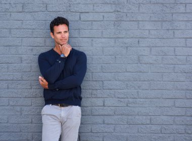 Yakışıklı adam çene üzerinde el ile düşünme 