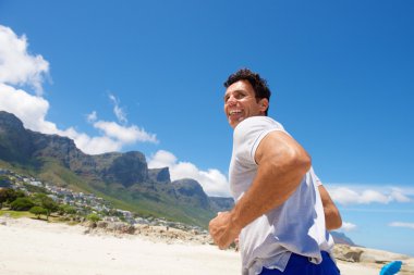 Sahilde koşan aktif orta yaşlı adam