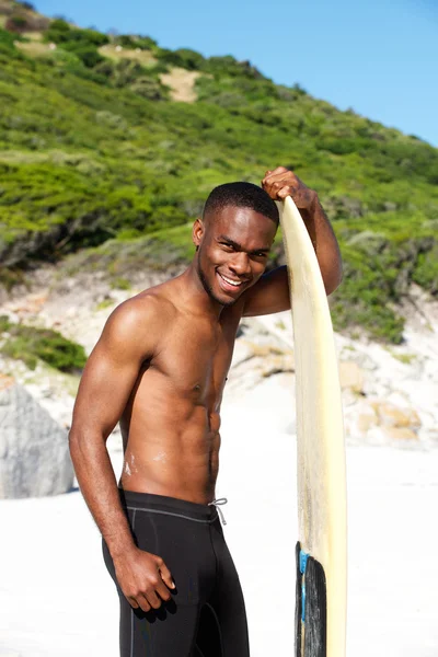 Young african man with surfboard — Stock Photo, Image