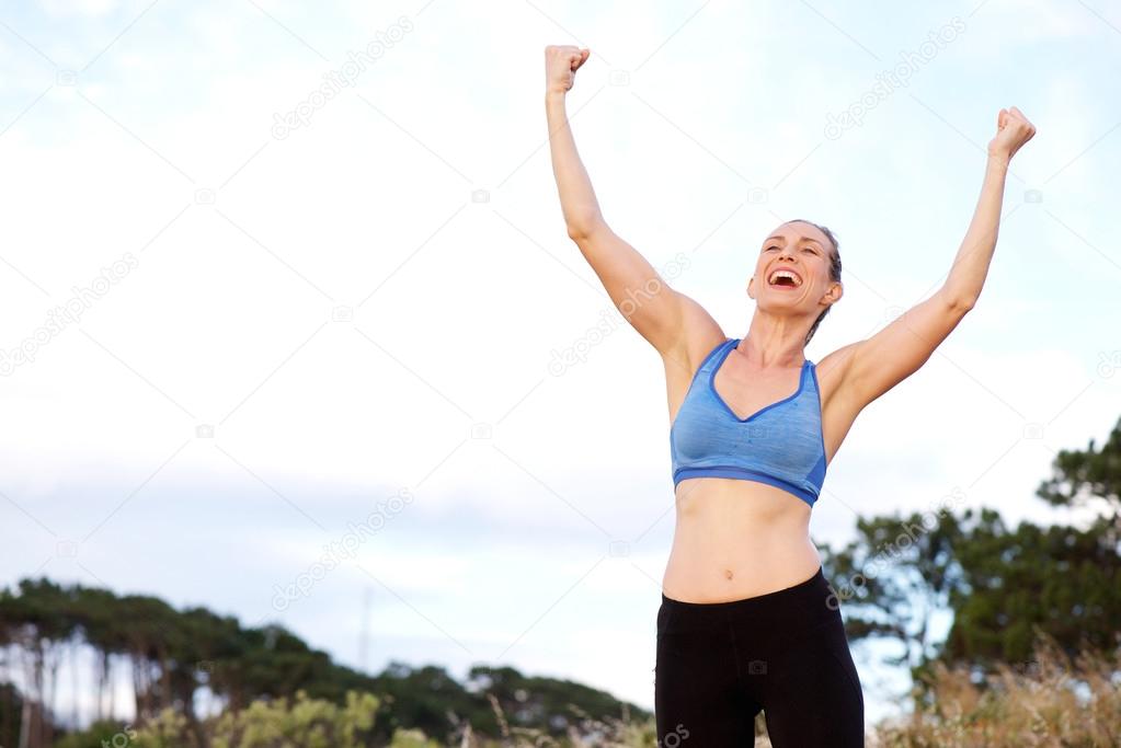 Sports woman with raised arms Stock Photo by ©mimagephotos 109740862