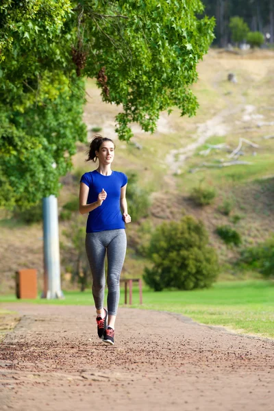 Woman running outdoors on path — Stock Photo, Image