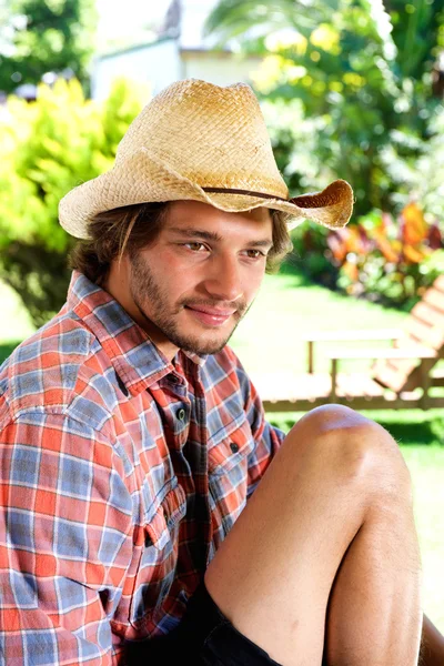 Young man with beard sitting outside — Stock Photo, Image