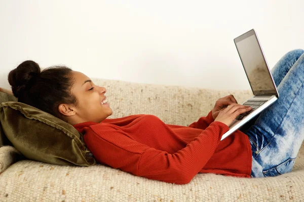 Attraktive junge Frau tippt auf Laptop — Stockfoto