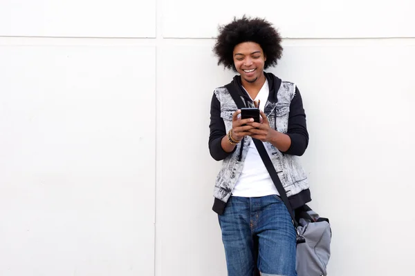 Junger Mann mit Afro schaut aufs Handy — Stockfoto