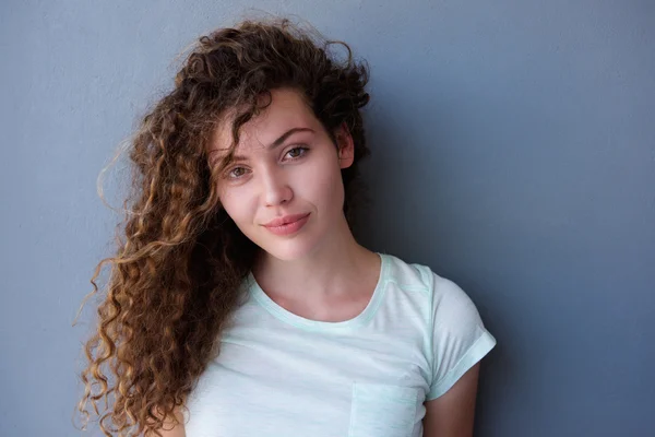 Pensive teen girl standing with curly hair — Stock Photo, Image