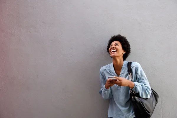 Laughing american woman with mobile phone — Stock Photo, Image