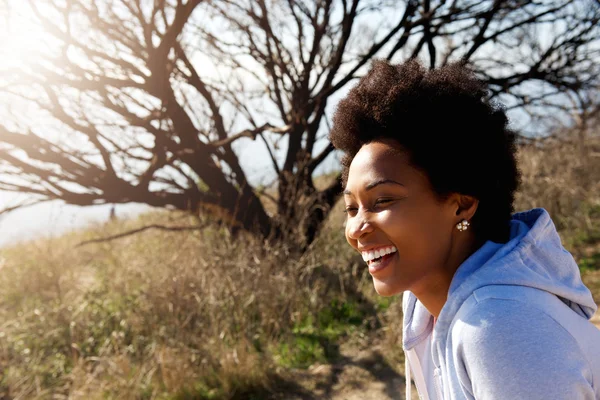 Beautiful african woman sitting outdoors — Stock Photo, Image