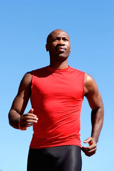 Young active man running outdoors — Stock Photo, Image