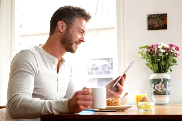 Happy older man with tablet drinking coffee — Stock Photo, Image