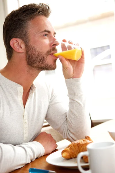 Handsome middle age man drinking juice — Stock Photo, Image