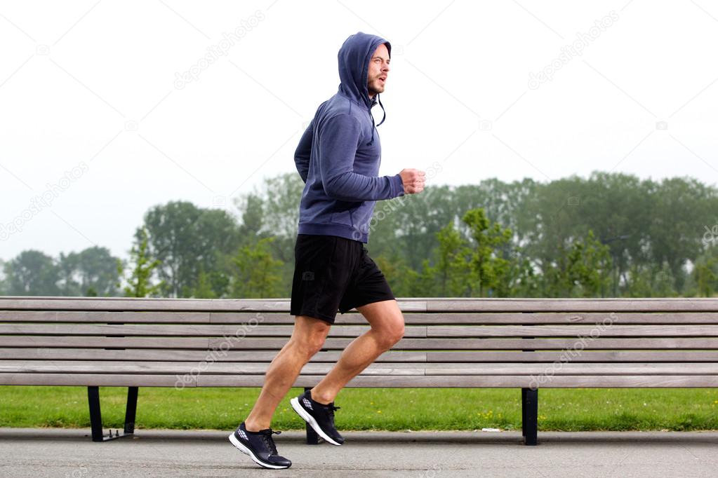 Sporty man jogging in a park stock photo