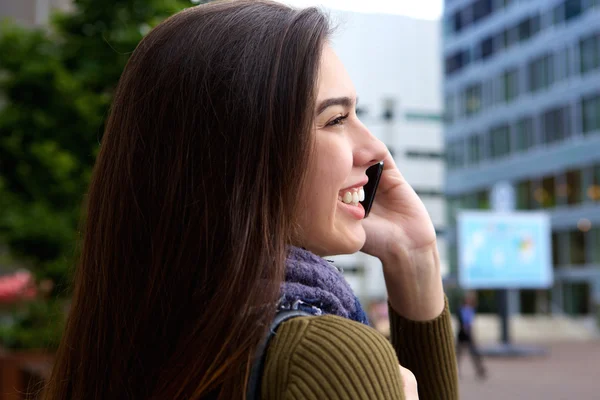 Smiling young woman talking on phone — Stock Photo, Image