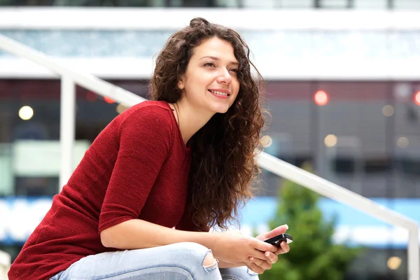 Attractive young woman sitting outside — Stock Photo, Image
