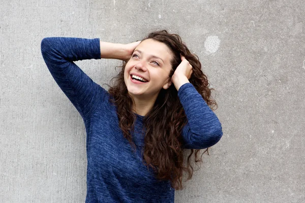 Woman standing against gray wall — Stock Photo, Image