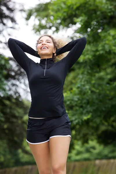 Female athlete with hands behind head — Stock Photo, Image