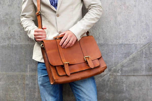 Homem com bolsa de ombro de couro em pé parede — Fotografia de Stock