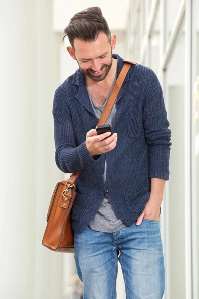 Счастливый зрелый парень с помощью мобильного телефона — стоковое фото