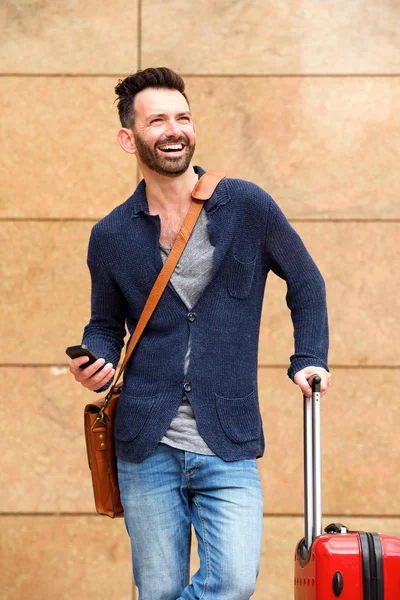 Man standing outdoors with bag — Stock Photo, Image