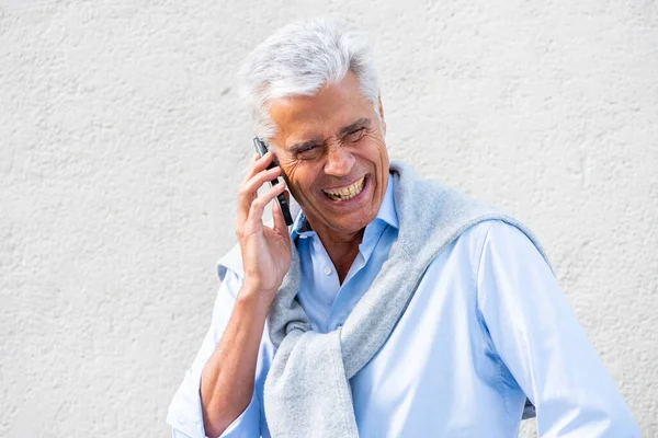 Beyaz Duvarda Cep Telefonuyla Gülen Konuşan Yaşlı Bir Adamın Portresini — Stok fotoğraf
