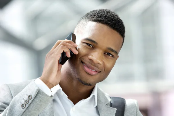Handsome young man smiling with cellphone — Stock Photo, Image