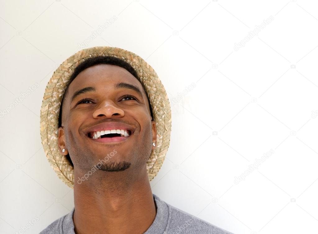 Handsome young man laughing with hat