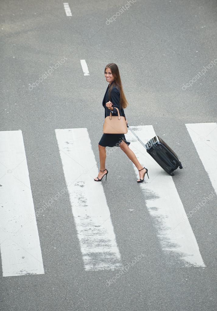 Business woman crossing at zebra crossway 