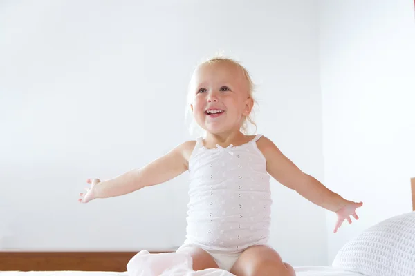 Smiling little girl with arms raised — Stock Photo, Image