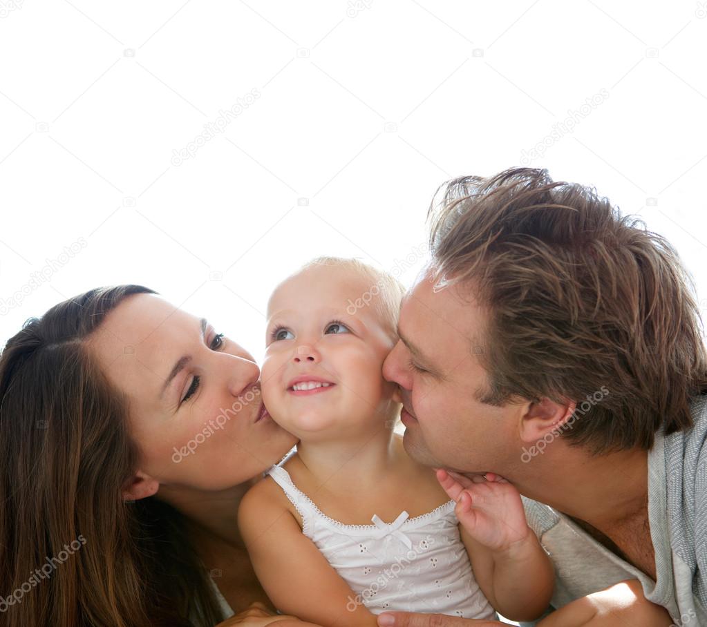 Happy parents kissing baby