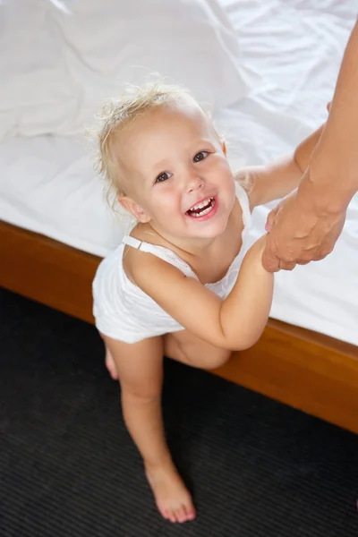 Cute baby girl holding adult hands — Stock Photo, Image