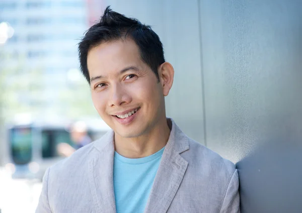 Charming asian man smiling outdoors — Stock Photo, Image