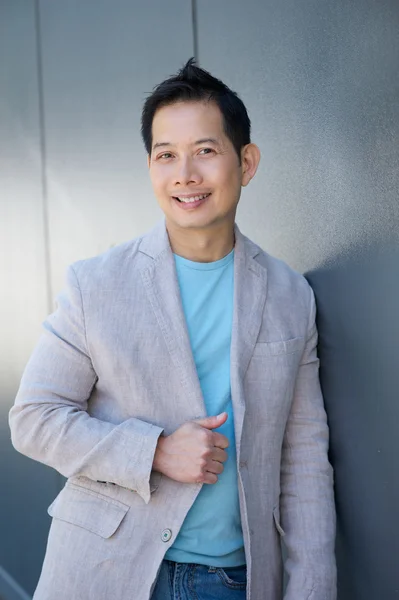 Attractive asian man smiling outdoors — Stock Photo, Image