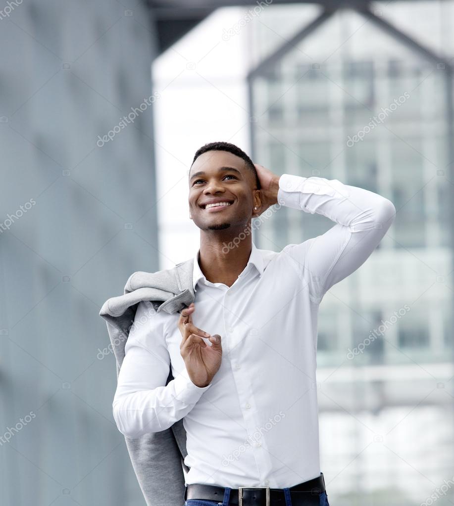 Cheerful young man smiling with white shirt