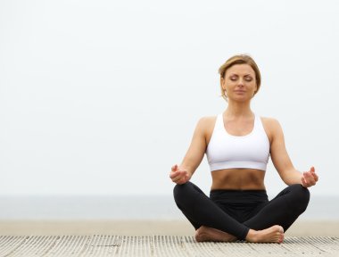 açık havada yoga pose içinde oturan genç kadın