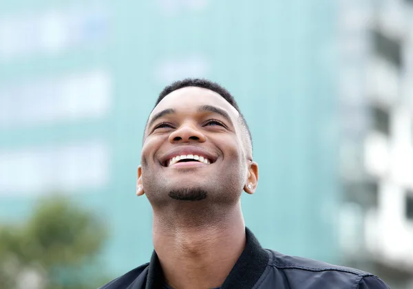 Cheerful young man laughing outdoors — Stock Photo, Image