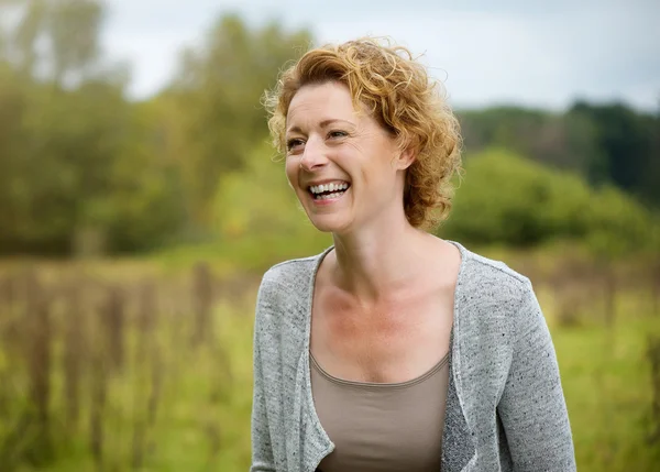Smiling middle aged woman outdoors — Stock Photo, Image