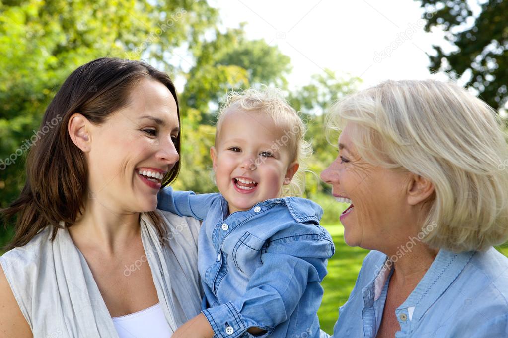 Smiling baby with mother and grandmother