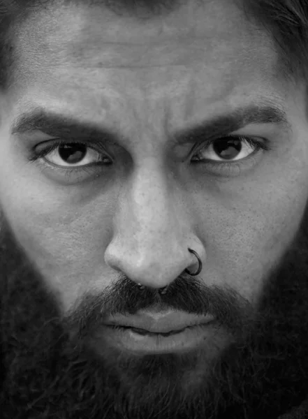 Black and white portrait of man with beard and nose piercing — Stock Photo, Image