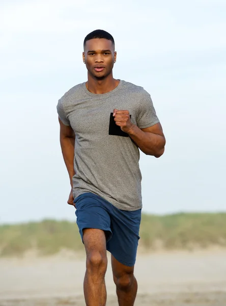 Healthy young black man running outdoors — Stock Photo, Image