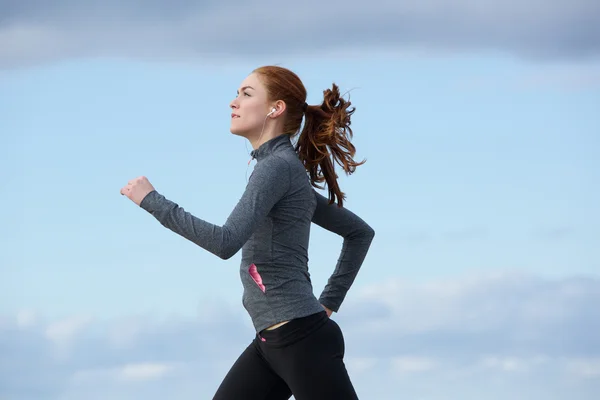 Healthy young woman running outdoors — Stock Photo, Image