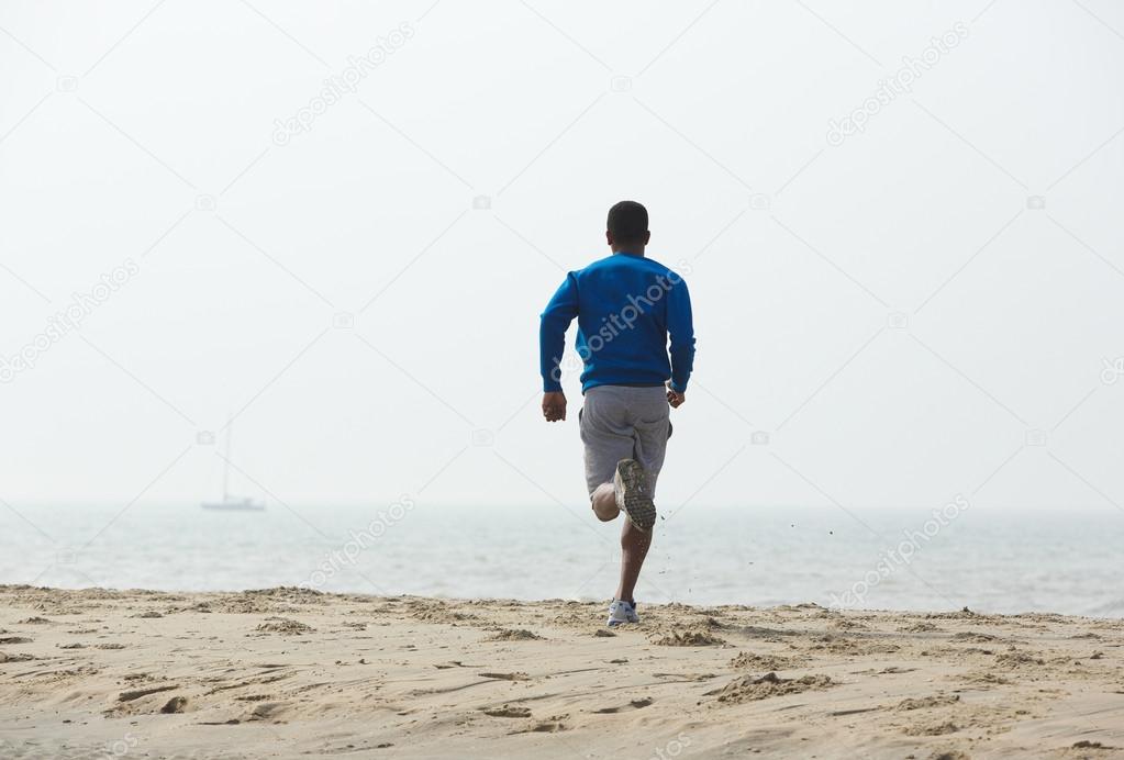 Rear view african american man running 