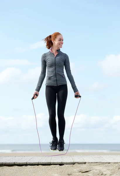 Woman exercising with jump rope outdoors — Stock Photo, Image