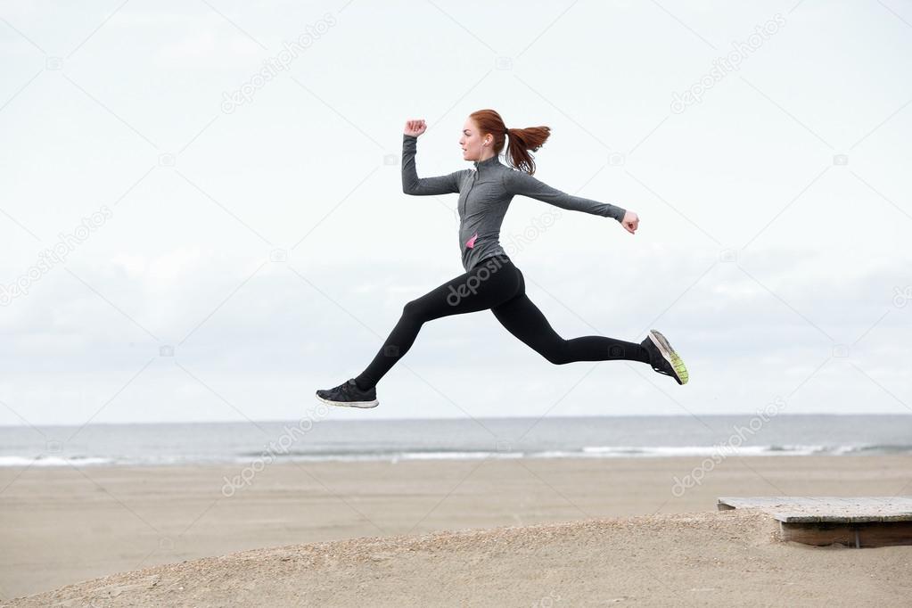 Fit young woman running and jumping 