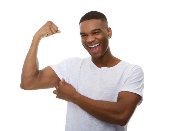 Happy young man flexing bicep muscle — Stock Photo, Image