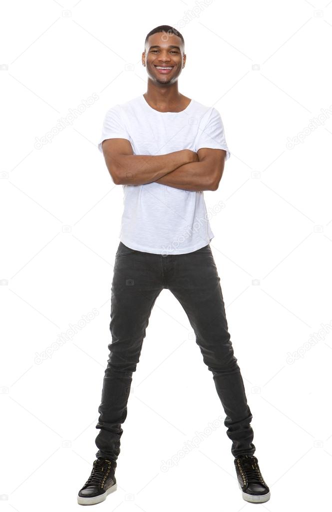 Full length portrait of a cool young guy smiling with arms crossed 