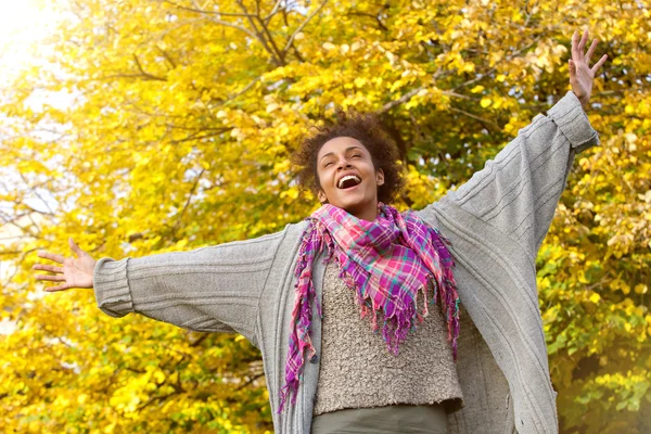 Zorgeloos jonge african american vrouw met uitgestrekte armen — Stockfoto