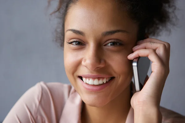 Vacker svart kvinna ler med mobiltelefon — Stockfoto