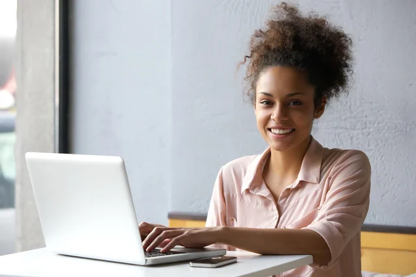 Young woman working on laptop in office — Stock Photo, Image