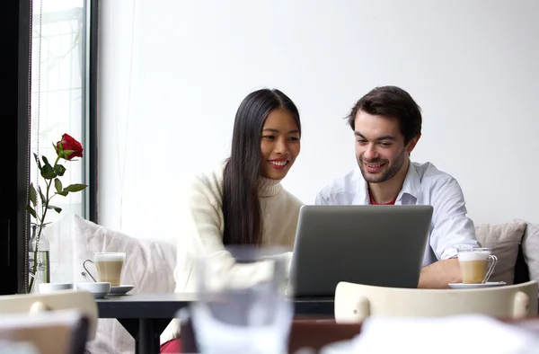 Young man and woman working on laptop — Stock Photo, Image