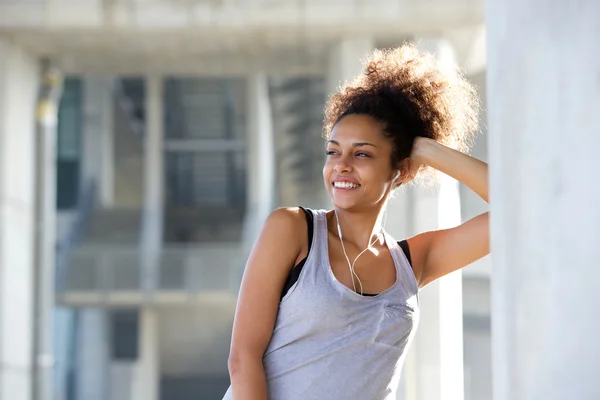 Hermosa joven mujer deportiva sonriendo con auriculares —  Fotos de Stock