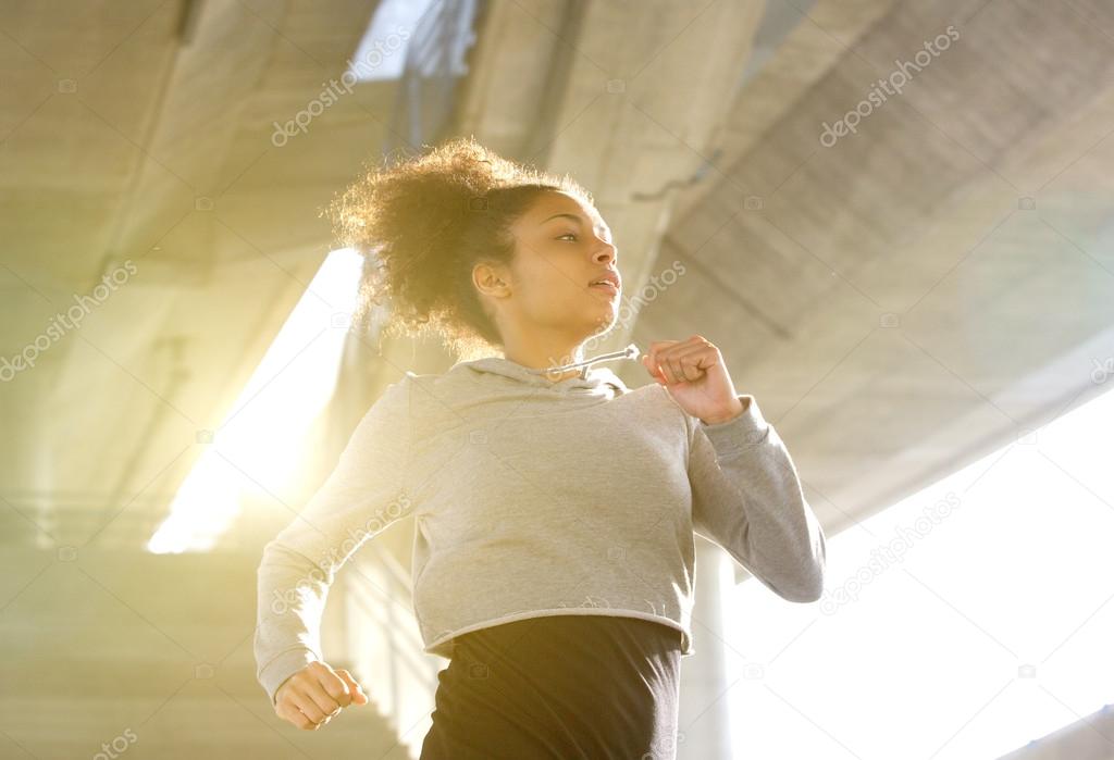 Young woman running in urban environment